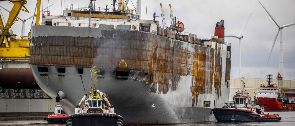 This photograph taken on September 21, 2023, shows the Panamanian-registered car carrier ship Fremantle Highway ship being towed from the Eemshaven to the port of Rotterdam, where it is planned to be dismantled. A fire broke out on the ship late on July 25, 2023, killing one crew member, and prompting a massive effort to extinguish the flames. The ship was carrying more than 3,700 cars at the time of the fire.