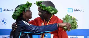 Winner of the women's race Ethiopia's Tigist Assefa (L) and winner of the men's race Kenya's Eliud Kipchoge celebrate on the podium after the Berlin Marathon on September 24, 2023 in Berlin, Germany. Assefa smashed the women's marathon world record in Berlin, winning in 2hr 11min 53sec, more than two minutes ahead of the previous mark. (Photo by Tobias SCHWARZ / AFP)