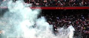 This photograph taken on September 24, 2023, shows smoke rising from fireworks thrown on the field by Ajax' supporters during the Dutch Eredivisie football match between Ajax Amsterdam and Feyenoord at the Johan Cruijff Arena in Amsterdam. (Photo by Olaf Kraak / ANP / AFP) / Netherlands OUT