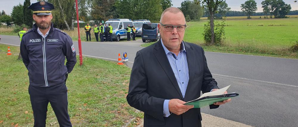 Minister Michael Stübgen (CDU) vor einer Polizeikontrolle in Roggosen 