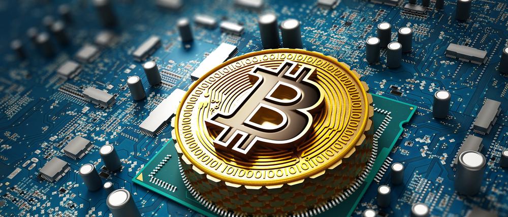 Crypto currency / Blockchain concept with coin on the motherboard.