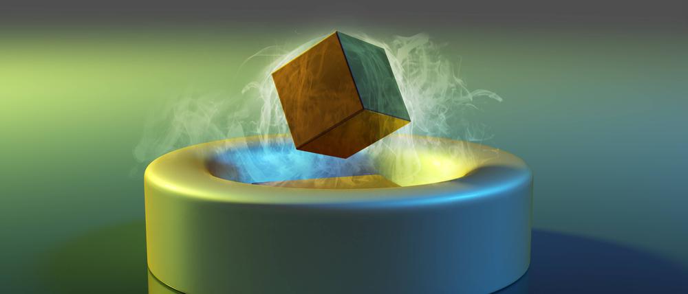 Illustration des magnetischen Schwebens unter Verwendung eines keramischen Hochtemperatursupraleiters. Ein magnetisierter Würfel schwebt frei über einer stickstoffgekühlten Platte aus supraleitender Keramik.