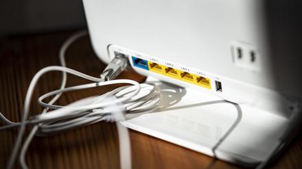 Langsames Internet? Ein LAN-Kabel steckt im DSL-Steckplatz eines WLAN-Routers.
