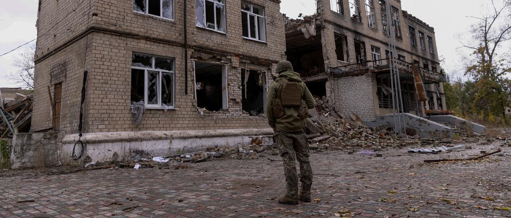 Ein ukrainischer Polizist vor einem zerstörten Gebäude in Awdijiwka