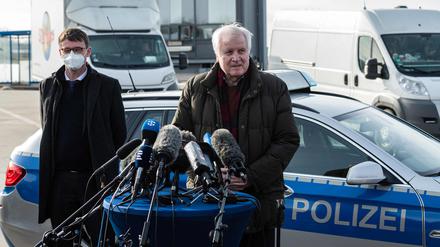 German Interior Minister Horst Seehofer (R) addresses the media as Saxony State Interior Minister Roland Woeller (L) listens during their visit of Germany's Federal Police that carries out controls at the German-Czech border in an attempt to stem the spread of the new coronavirus variants, in Breitenau, eastern Germany, on February 18, 2021. - Germany partially closed its borders with the Czech Republic and Austria's Tyrol on February 14 over a troubling surge in coronavirus mutations, defying condemnation from the European Union. Germany's new rules on its borders mean only German nationals or residents of Germany are allowed through. Essential workers in sectors such as health and transport can also enter, as well as those crossing for urgent humanitarian reasons, according to the German interior ministry. Everyone must be able to provide a recent negative coronavirus test. (Photo by JENS SCHLUETER / AFP)