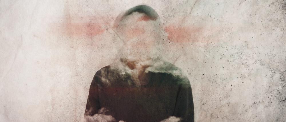 A mental health concept. Of a man with his head covered in clouds. With a grunge, artistic edit