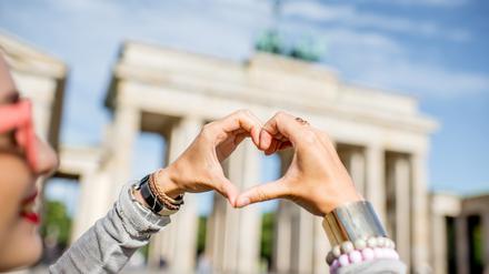 Eine junge Frau liebt Berlin offenbar noch mehr als der Autor dieses Textes und hat sich extra vor dem Brandenburger Tor fotografieren lassen.
