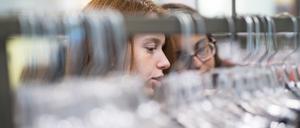 Two teenager girls, sisters, shopping in the clothing outlets retail store in Pennsylvania, Poconos region, USA