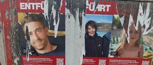 Teilweise abgerissene Plakate von Opfern des Hamas-Angriffs auf Israel  hängen auf einem Kasten in Berlin. 