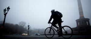 Ein Mann fährt am 23.11.2012 im Nebel an der Siegesäule in Berlin vorbei. Foto: Kay Nietfeld/dpa +++(c) dpa - Bildfunk+++