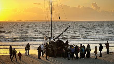 Ein am Weststrand der Insel Norderney gestrandetes Segelschiff mit Schaulustigen.