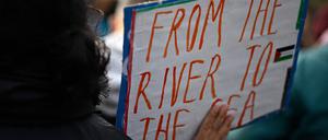 A demonstrator displays a placard with the lettering 'From the river to the sea' during a rally in solidarity with Palestinians at Oranienplatz Square in Berlin's Kreuzberg district, Germany, on November 11, 2023. Thousands of civilians, both Palestinians and Israelis, have died since October 7, 2023, after Palestinian Hamas militants based in the Gaza Strip entered southern Israel in an unprecedented attack triggering a war declared by Israel on Hamas with retaliatory bombings on Gaza. (Photo by Tobias SCHWARZ / AFP)