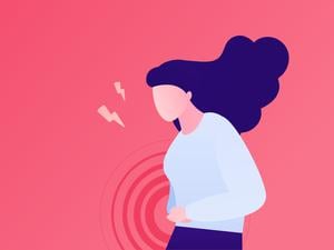 Painful female periods concept. Vector flat character illustration. Woman standing and suffering menstrual abdominal pain isolated on pink background. Design for health care.