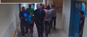 This screen grab taken from a security camera footage and released by the Israeli army on November 19, 2023, shows what the army reports as Hamas fighters leading hostages into Al-Shifa hospital on November 7. (Photo by Israeli Army / AFP) / === RESTRICTED TO EDITORIAL USE - MANDATORY CREDIT "AFP PHOTO / Handout / Israeli Army' - NO MARKETING NO ADVERTISING CAMPAIGNS - DISTRIBUTED AS A SERVICE TO CLIENTS ==