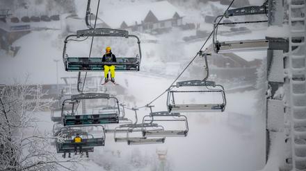 Freizeitsportler sitzen in einem Sessellift (Symbolbild).