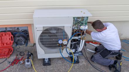 plumber at work installing a circulation pump