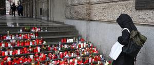 A place of worship with candles is seen in front of the Faculty of Arts, Charles University. 