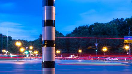 ARCHIV - 26.07.2023, Berlin: Eine Blitzsäule steht am Kreisverkehr an der Siegessäule, während im Hintergrund vorbeifahrende Fahrzeuge Lichtspuren hinterlassen (Aufnahme mit Langzeitbelichtung). (zu: «Weitere Blitzer in Berlin - wenig Wirkung auf Autofahrer») Foto: Monika Skolimowska/dpa +++ dpa-Bildfunk +++