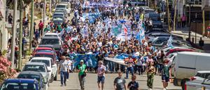 Demonstranten marschieren durch eine Stadt in Patagonien gegen das Reformvorhaben vom argentinischen Präsidenten Milei. 