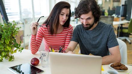 Male and female graphic designers using laptop in office
KI Job Search