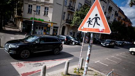 Ein SUV fährt an einem Hinweisschild für Schüler in der Prenzlauer Allee vorbei (Archivbild vom 10.08.2023).