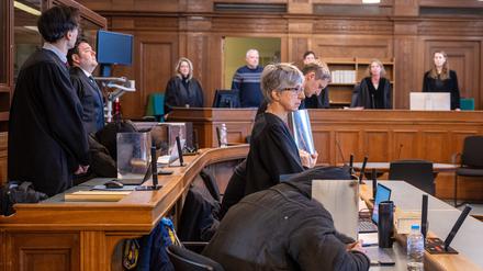 Vier Angeklagte sitzen vor Beginn der Verhandlung im Gerichtssaal im Kriminalgericht Moabit in Begleitung ihrer Anwälte Regina Götz (vorne r), Einar Aufurth (hinten r), Marten Mittelstädt (vorne l) und Michael Lippa (hinten l) und verdecken dabei ihre Gesichter mit Pappe. Fast vier Jahre nach dem Angriff auf ein ZDF-Team am Rande einer Demonstration gegen die staatlichen Corona-Maßnahmen in Berlin begann am 8.1.2024 der Prozess gegen drei Männer und eine Frau aus Berlin und Baden-Württemberg. Das Urteil ist nun rechtskräftig.