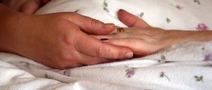 Hände auf der Bettdecke einer Bewohnerin im Evangelischen Hospiz Stendal. Die Angebote von Hospizen und Palliativdiensten sind in Sachsen-Anhalt weiterhin stark gefragt.