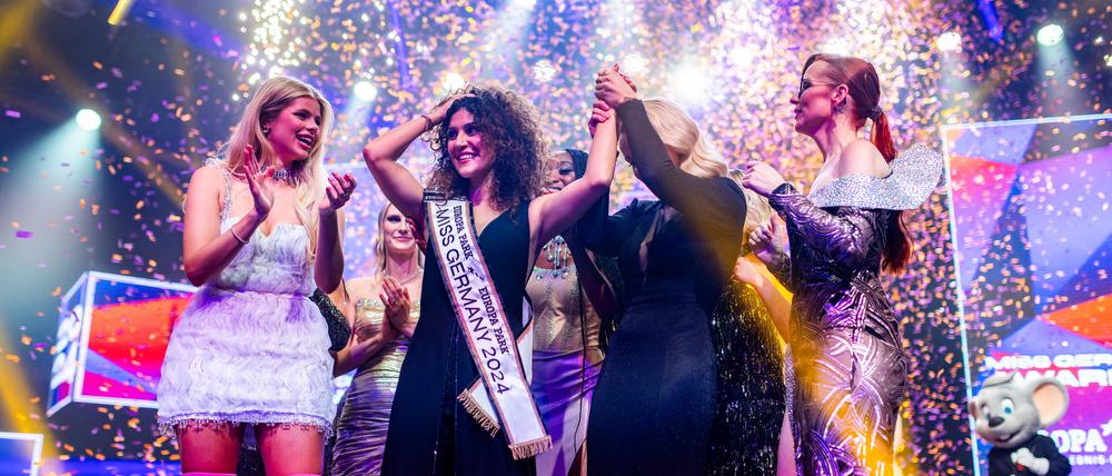 24.02.2024, Baden-Württemberg, Rust: Apameh Schönauer (3.v.l.) feiert gemeinsam mit ihren Mitbewerberinnen ihren Titelgewinn als Miss Germany 2024. Das Finale zur Wahl der Miss Germany findet zum 22. Mal im Europa-Park Rust statt. Foto: Philipp von Ditfurth/dpa +++ dpa-Bildfunk +++