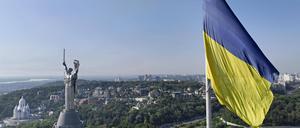 Das Mutterlandsdenkmal in Kiew aus der Luft. Im Vordergrund eine ukrainische Fahne.