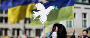 A person holds a dove-shaped sign during an anti-war demonstration "Stop the War. Peace and Solidarity for the People in Ukraine" against Russia's invasion of Ukraine, near the Brandenburg Gate in Berlin, Germany, March 13, 2022. REUTERS/Christian Mang