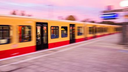 Eine S-Bahn fährt morgens am Bahnhof ab. 