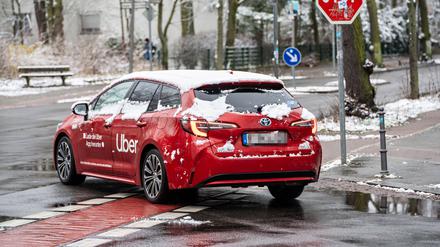 Ein Mietwagenauto auf den Straßen von Berlin. Das Fahrzeug gehört nicht Uber, der Konzern hat nur Werbung darauf geklebt.