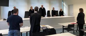 18.03.2024, Berlin: Ein Berliner Kommissar und sein Anwalt Robert Hildebrand (2.v.l) stehen im Gerichtsaal. Der Kommissar ist auf sozialen Medien als «Officer Denny» unterwegs. Sein Arbeitgeber hat damit ein Problem, sieht Schäden für das Ansehen der Polizei. Foto: Marion van der Kraats/dpa +++ dpa-Bildfunk +++