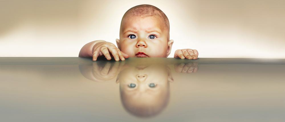 Ein Baby blickt ernst in die Welt.