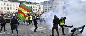 Protesters surrounded by tear gas take part in a rally gathering the Kurdish community, following the March 24 riots in Heusden-Zolder, in Brussels on March 25, 2024. (Photo by ERIC LALMAND / Belga / AFP) / Belgium OUT