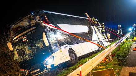 Einsatzkräfte der Feuerwehr arbeiten an einer Unfallstelle auf der Autobahn 44 an dem verunfallten Bus. 