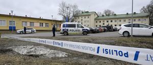 Polizeibeamte bewachen den Tatort hinter den Absperrbändern bei der Viertola-Schule in der finnischen Stadt Vantaa nördlich von Helsinki.