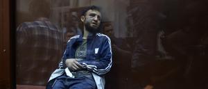Dalerdjon Barotovich Mirzoyev suspected of taking part in the attack of a concert hall that killed 137 people, the deadliest attack in Europe to have been claimed by the Islamic State jihadist group, sits in the defendant cage as he waits for his pre-trial detention hearing at the Basmanny District Court in Moscow on March 24, 2024. A Russian court on March 24, 2024 ordered the continued detention of the first suspect in the Moscow concert hall attack that left more than 130 people dead. Moscow's Basmanny district court ordered Dalerdjon Barotovich Mirzoyev, a citizen of Tajikistan, to remain in custody until May 22 pending a terrorism investigation, according to a statement from Moscow city courts on Telegram. (Photo by TATYANA MAKEYEVA / AFP)