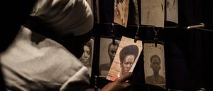 (FILES) A picture taken on April 29, 2018 shows a visitor looking at victims' portraits at the Kigali Genocide Memorial in Kigali, Rwanda. Rwanda will on April 7, 2024 commemorate the 30th anniversary of the genocide during which Hutu extremists targeting the Tutsi minority slaughtered around 800,000 people in a massacre lasting 100 days. (Photo by Yasuyoshi CHIBA / AFP)