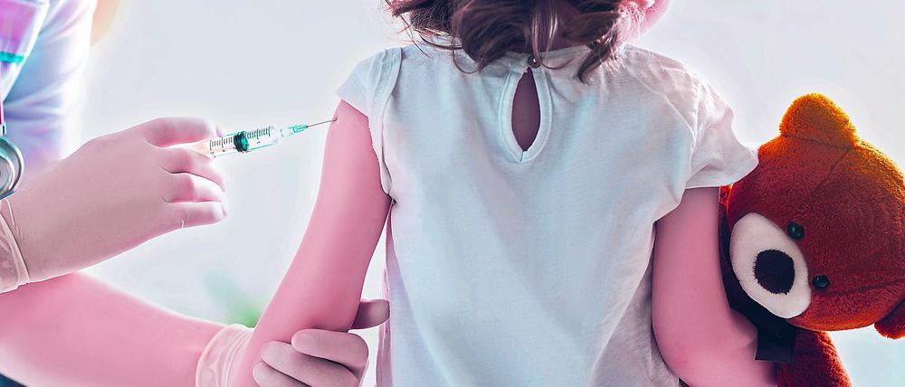 A doctor making a vaccination to a child