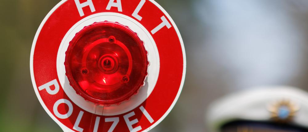 ARCHIV - 21.04.2023, Bayern, Nürnberg: Ein Polizist zieht ein Fahrzeug mit seiner Kelle aus dem Verkehr. (zu dpa: «Polizei zu «Carfreitag»: Autofans haben sich an Spielregeln gehalten») Foto: Daniel Karmann/dpa +++ dpa-Bildfunk +++