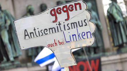Ein Teilnehmer der Kundgebung „Allianz gegen Antisemitismus ruft zur Solidarität mit Israel auf“ hält ein Schild mit der Aufschrift „Gegen Antisemitismus auch bei den Linken“ hoch.