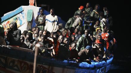 Migranten befinden sich dicht gedrängt in einem Holzboot, während sie zum Hafen in La Restinga auf der Kanareninsel El Hierro geschleppt werden.