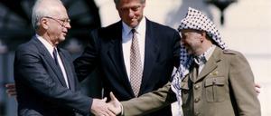 Washington 1993, als eine Lösung greifbar schien: Der israelische Ministerpräsident Yitzhak Rabin und der PLO-Vorsitzende Yasser Arafat nach der Unterzeichnung des israelisch-palästinensischen Friedensabkommens. In der Mitte: US-Präsident Bill Clinton.