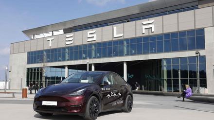 (FILES) A Tesla Model Y car stands in front of the company’s plant as Tesla CEO Elon Musk visits the company’s electric car plant in Gruenheide near Berlin, eastern Germany, on March 13, 2024, as employees resumed work after production had to be halted due to a suspected arson attack that caused a power outage. 