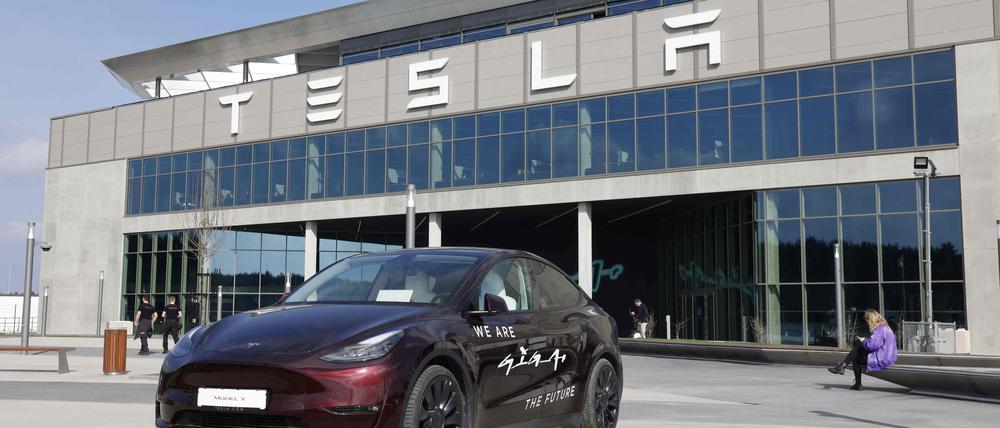 (FILES) A Tesla Model Y car stands in front of the company’s plant as Tesla CEO Elon Musk visits the company’s electric car plant in Gruenheide near Berlin, eastern Germany, on March 13, 2024, as employees resumed work after production had to be halted due to a suspected arson attack that caused a power outage. 