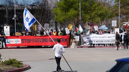 A counter-protester holding an Israeli flag walks into the parking lot near a protest at Google Cloud offices in Sunnyvale, California, U.S. on April 16, 2024. REUTERS/Nathan Frandino