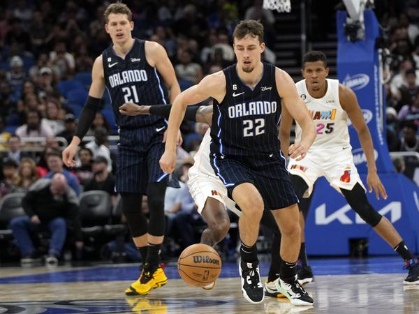 Basketball: NBA, Hauptrunde, Orlando Magic - Miami Heat. Franz Wagner (22) von den Orlando Magic rennt einem verlorenen Ball hinterher, vor dem Center Moritz Wagner (21) und Orlando Robinson (25) von den Miami Heat. (zu dpa: «Kindheitstraum wird wahr: Wagner-Brüder geben Playoff-Debüt») +++ dpa-Bildfunk +++