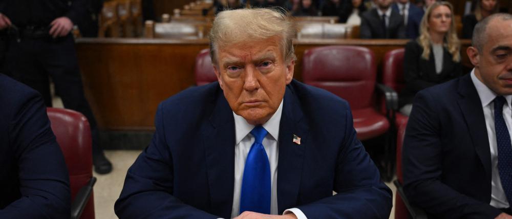 TOPSHOT - Former US president and Republican presidential candidate Donald Trump looks on at Manhattan Criminal Court during his trial for allegedly covering up hush money payments linked to extramarital affairs in New York on April 22, 2024. Donald Trump's unprecedented criminal trial is set for opening statements after final jury selection ended Friday, leaving the Republican presidential candidate facing weeks of hostile testimony that will overshadow his White House campaign. (Photo by ANGELA WEISS / POOL / AFP)