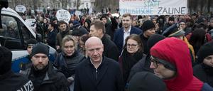 Der Regierende Bürgermeister Kai Wegner und Verkehrssenatorin Manja Schreiner (beide CDU) gehen begleitet von Demonstranten durch den Görlitzer Park.